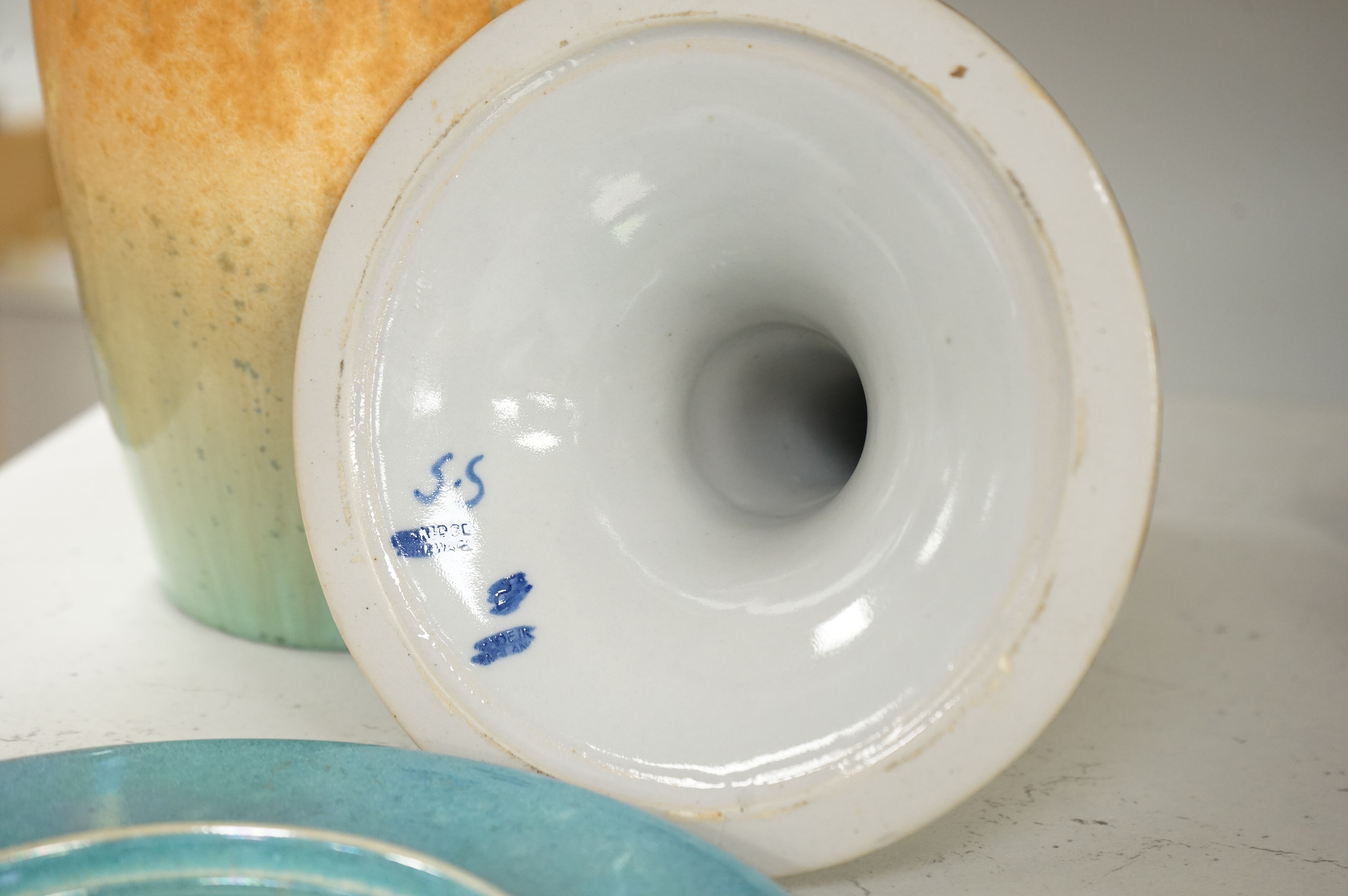 A Ruskin souffle glazed vase, impressed 1932, a Ruskin circular dish and an earthenware candlestick, tallest 21cm (3)